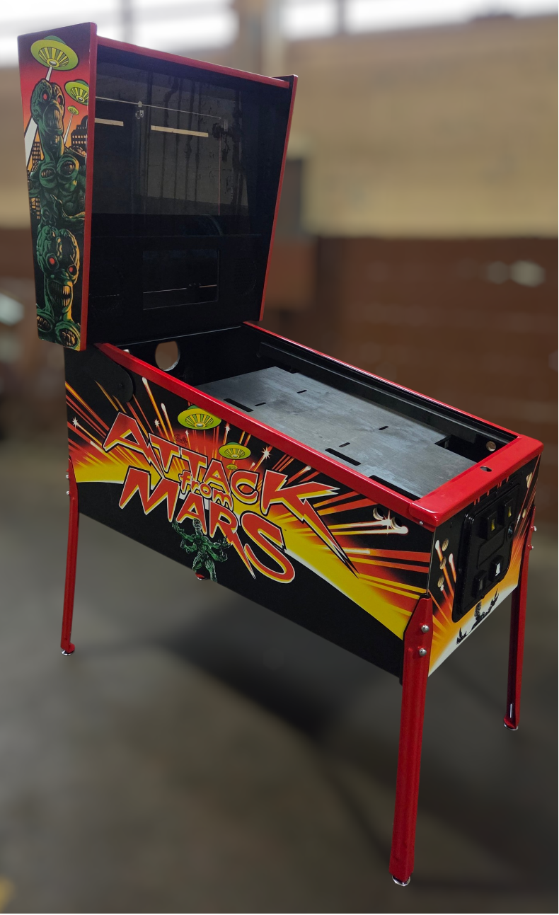 virtual pinball cabinet with 'Attack from Mars' design in a room with a blurred background partial side